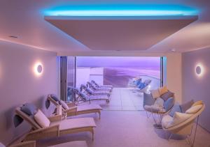 ブラントンにあるSaunton Sands Hotel Source Spa and Wellnessの大きな窓のある待合室(ソファ、椅子付)