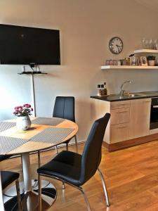 a kitchen and dining room with a table and chairs at Thoristun Apartments in Selfoss