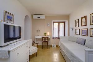 a living room with a white couch and a tv at Beautiful Apartment Jelena 1 in Veli Lošinj