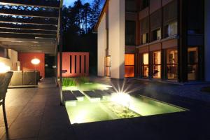 a courtyard of a building with a pool with lights at Carrera - Ferienhaus mit Traumgarten (120m2) für max. 2 Personen in Valendas