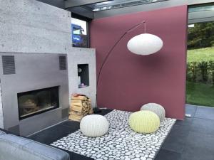 a living room with a fireplace and two chairs at Carrera - Ferienhaus mit Traumgarten (120m2) für max. 2 Personen in Valendas