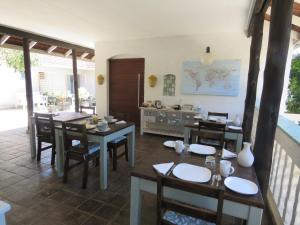 a dining room with wooden tables and chairs at Bare Feet Retreat in Scottburgh
