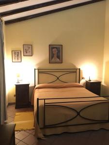 a bedroom with a large bed with two night stands at Agriturismo Masseria Portiere Stella in Gerbini
