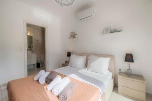 a white bedroom with a bed with towels on it at Villa Sea La Vie in Kiotari +21 photos