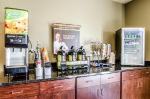 a kitchen with a counter with a drink dispenser at Cobblestone Inn & Suites - Ord in Ord