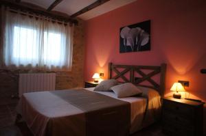 a bedroom with a bed with two lamps and a window at Balcón De Ares in Ares del Maestre