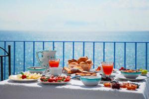 a table with food on it with a view of the ocean at Hotel Palladio in Giardini Naxos