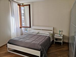 a bedroom with a bed and a window and a table at PATAVIUM APARTMENT in Padova