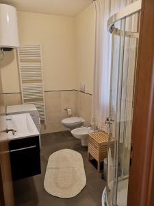 a bathroom with two toilets and a shower at PATAVIUM APARTMENT in Padova