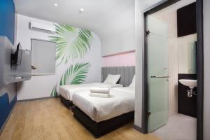 Postel nebo postele na pokoji v ubytování Bobotel Gatot Subroto Medan + 5 fotografií