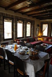 a dining room with a table with food on it at Guesthouse Petrino in Pezoúla