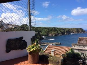 a view of the ocean from the balcony of a house at Ribeirinha House in Porto Formoso