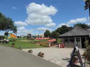 a park with a playground with a slide at Gite Le Bois Fleuri in Illiers
