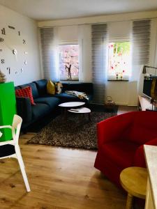 a living room with a blue couch and a table at Ferienwohnung Piesbach in Nalbach