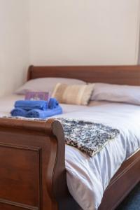 a bed with a wooden frame with a blanket on it at Eurovilla in Belfast