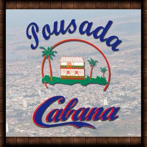 a sign with a palm tree and a hotel at Pousada Cabana in Avaré