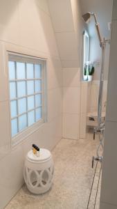 a white bathroom with a shower and a window at Stonehurst Place Bed & Breakfast in Atlanta