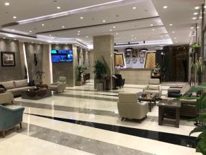 a lobby with couches and chairs in a building at Diamond Tower Hotel in Jeddah