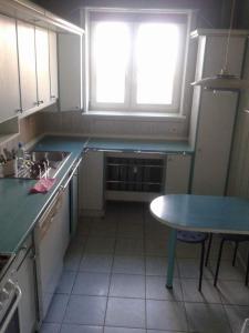 a kitchen with a sink and a table and a window at 1050 Śmiałego 36 - Tanie Pokoje - samodzielne zameldowanie - self check in in Poznań