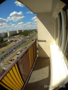 a balcony of a building with a view of a highway at 1050 Śmiałego 36 - Tanie Pokoje - samodzielne zameldowanie - self check in in Poznań