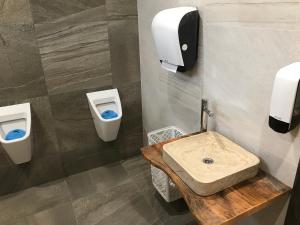 a bathroom with two toilets and a sink at Bezručova škola in Staré Hamry