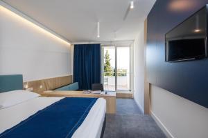 Postel nebo postele na pokoji v ubytování Hotel Osmine + 27 fotografií