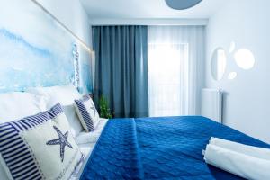 Postel nebo postele na pokoji v ubytování Blue Port Gardenia