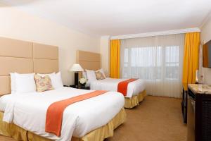 a hotel room with two beds and a window at Sea View Hotel in Miami Beach