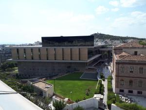 an aerial view of a building with a field in front at Check Point - Acropolis in Athens