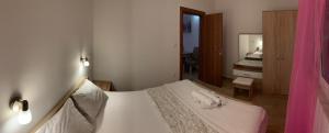 a bedroom with a bed with two towels on it at Apartmani Gaga in Tivat