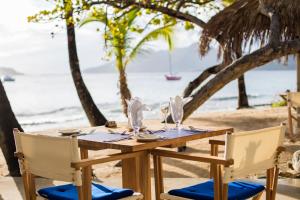 a table on the beach with a view of the ocean at The Palm Island Resort in Palm Island
