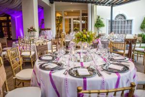 a table set up for a wedding with purple lighting at Hotel Mirador Plaza in San Salvador +65 photos