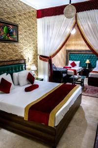 a bedroom with a large bed in a room at Rose Palace Hotel, Garden Town in Lahore