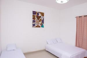 Postel nebo postele na pokoji v ubytování Residences Fama