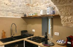 A kitchen or kitchenette at Trulli Storie di Puglia - Private Pool