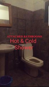 a bathroom with a white toilet and a sink at Lama Hotel - Cafe De Himalaya in Lukla