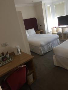 A bed or beds in a room at Granby Hotel 