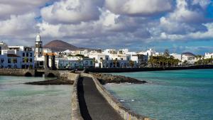 a city with a bridge over the water and buildings at Felisa Center in Arrecife