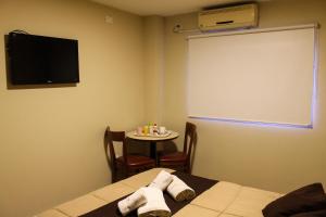 a room with a table and a television on it at Savannah Cordoba Hotel in Córdoba