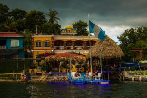 a boat in the water in front of a building at Hostal Casa de Grethel in Flores