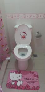 a bathroom with a toilet with a hello kitty sticker on it at Hello Kitty at Wind Residences Tagaytay in Tagaytay