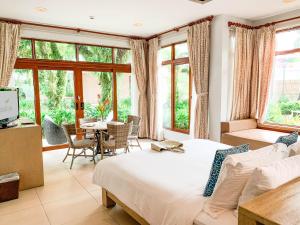 1 dormitorio con 1 cama, mesa y sillas en Misibis Bay en Cagraray