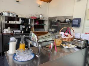 a kitchen with a counter with a mixer and some food at Muntri Grove in George Town