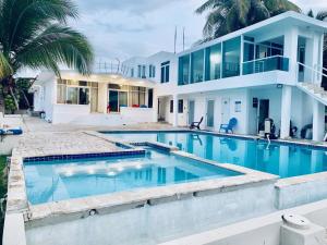 a house with a swimming pool in front of it at Ventana al Atlantico at Arecibo 681 Ocean Drive in Arecibo