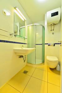 a bathroom with a sink and a shower and a toilet at Sunny Bobica Apartments in Vodice +59 photos