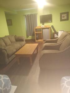 a living room with a couch and a coffee table at Econo Inn in Anchorage