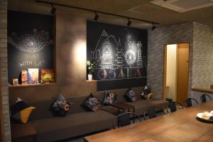 a living room with a couch and a table at Shinsaibashi House in Osaka