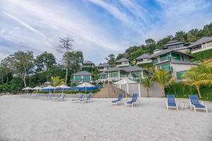 a group of chairs and umbrellas on a beach at Royale Chulan Cherating Villa in Cherating