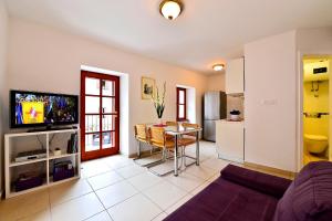 a living room with a kitchen and a dining room at Sunny Bobica Apartments in Vodice