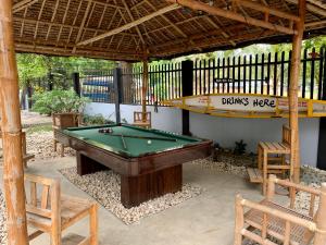 a pool table under a gazebo with a pool table at Old Castle in Anda